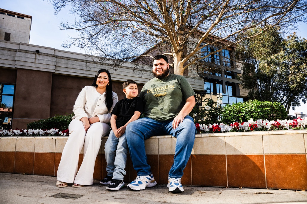 Adrian Preciado with his parents, sitting at Adventist Health White Memorial