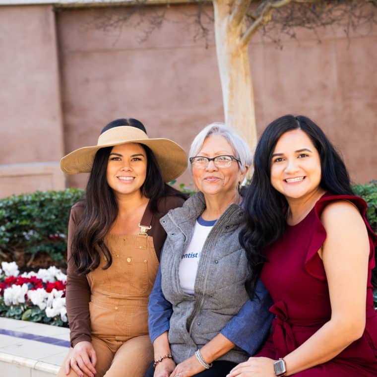 Rosa Mercado (middle) sitting with Community Resource Center team members