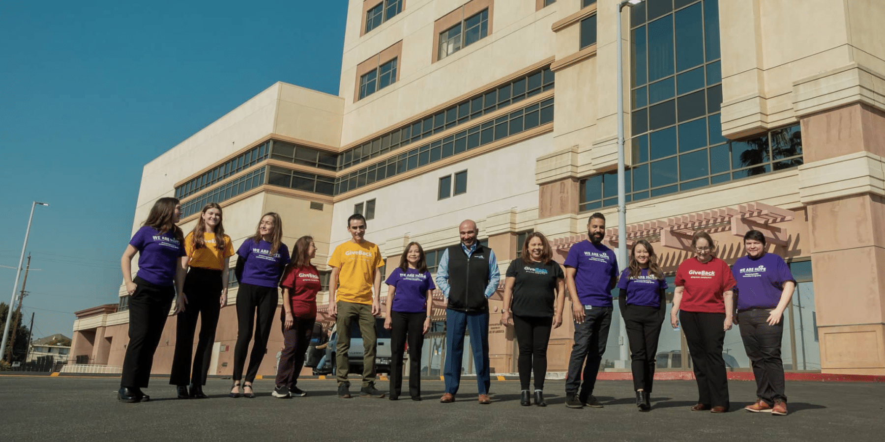 Staff from Adventist Health White Memorial Charitable Foundation stand in front of the hospital together